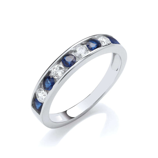Sapphire Blue CZ Eternity Ring in silver with sapphire blue and clear cubic zirconia stones, showcasing channel set design.